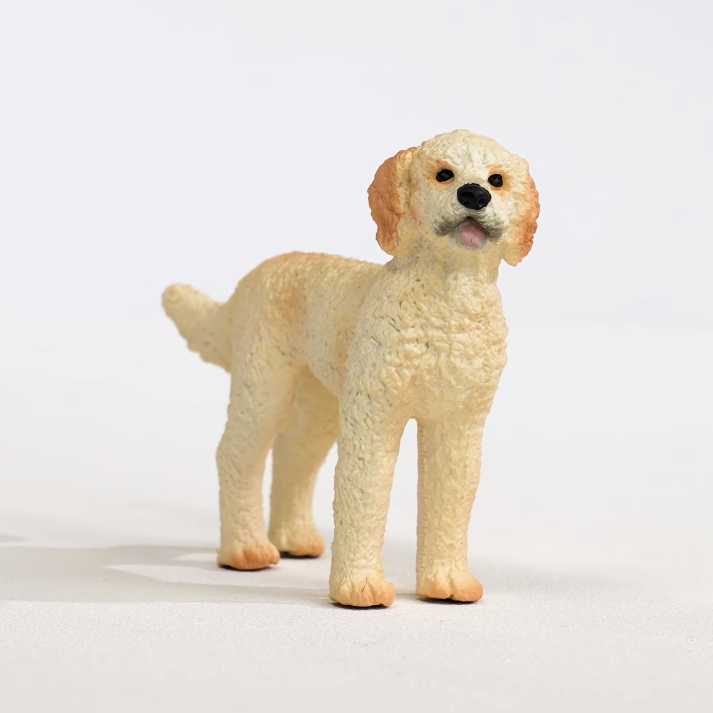 Goldendoodle figurine with curly cream fur and playful expression, perfect collectible toy for kids ages 3 and up.