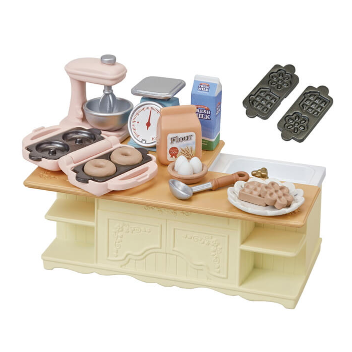 Kitchen Island with mixer, measuring scale, waffle and doughnut maker, molds, and baking accessories for kids.