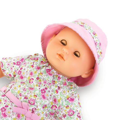 Bath Baby Coralie doll dressed in floral outfit and pink hat with closed eyes, perfect for cuddling and water play.