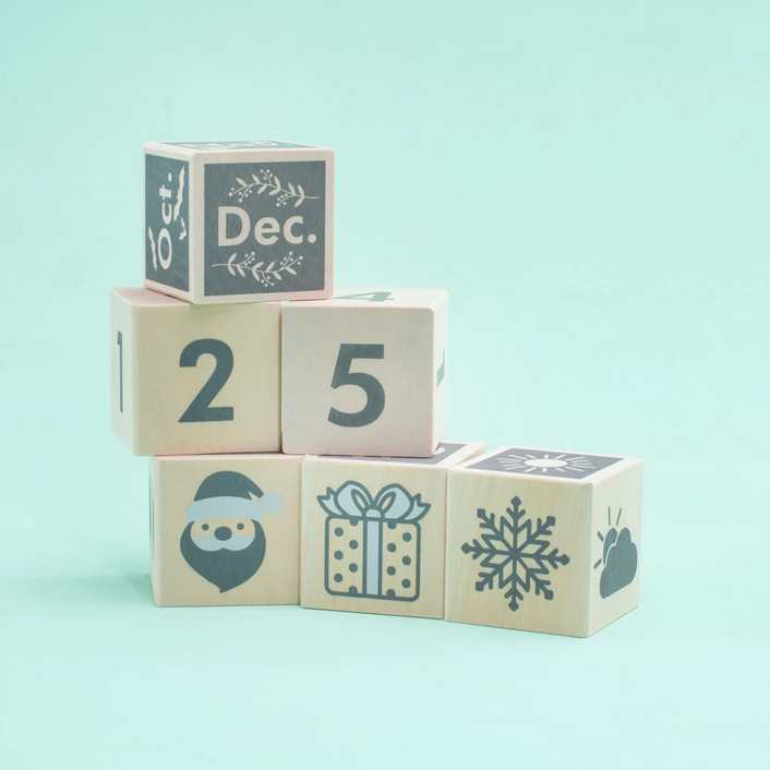 Perpetular Calendar Blocks showing December 25 with holiday and weather icons on sustainable wood cubes.