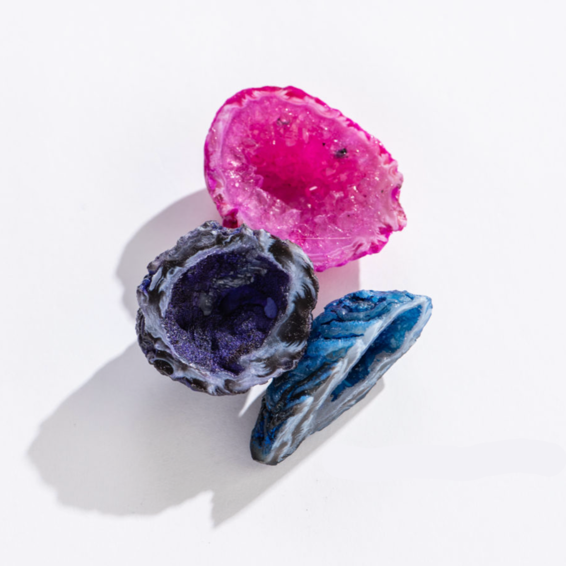 Rock | Dyed Ocos showing vibrant pink, purple, and blue geode stones with crystal formations, perfect for collections.