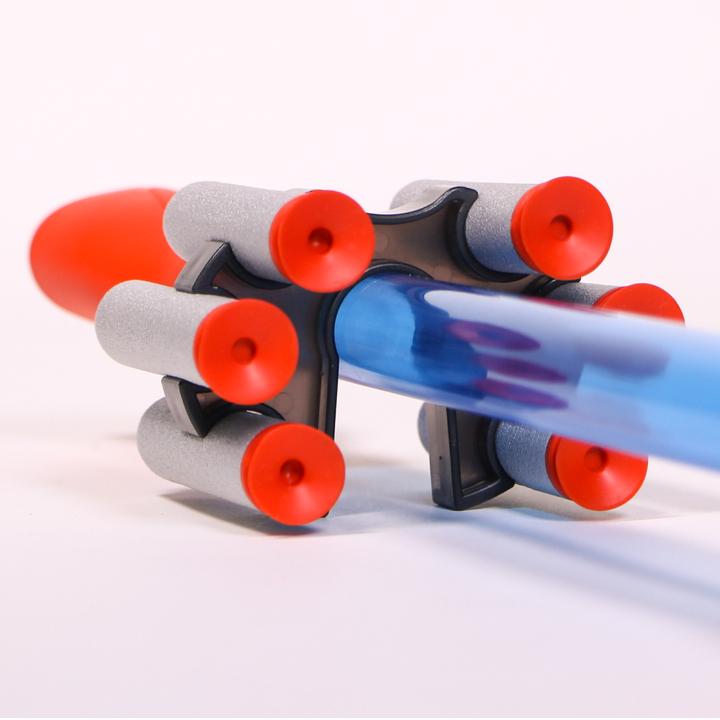 Blow Darts set with transparent blue blow tube and six soft foam suction cup darts arranged in a holder.