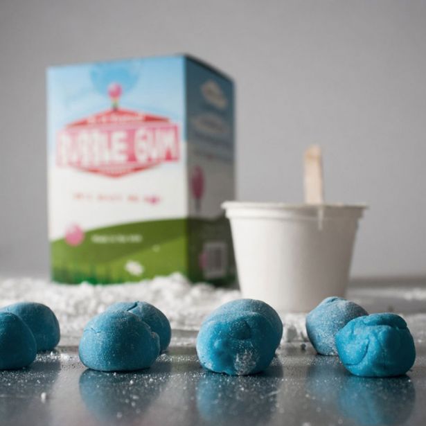 Bubble Gum Kit showing blue gum pieces with mixing cup and box in the background for homemade bubble gum fun.