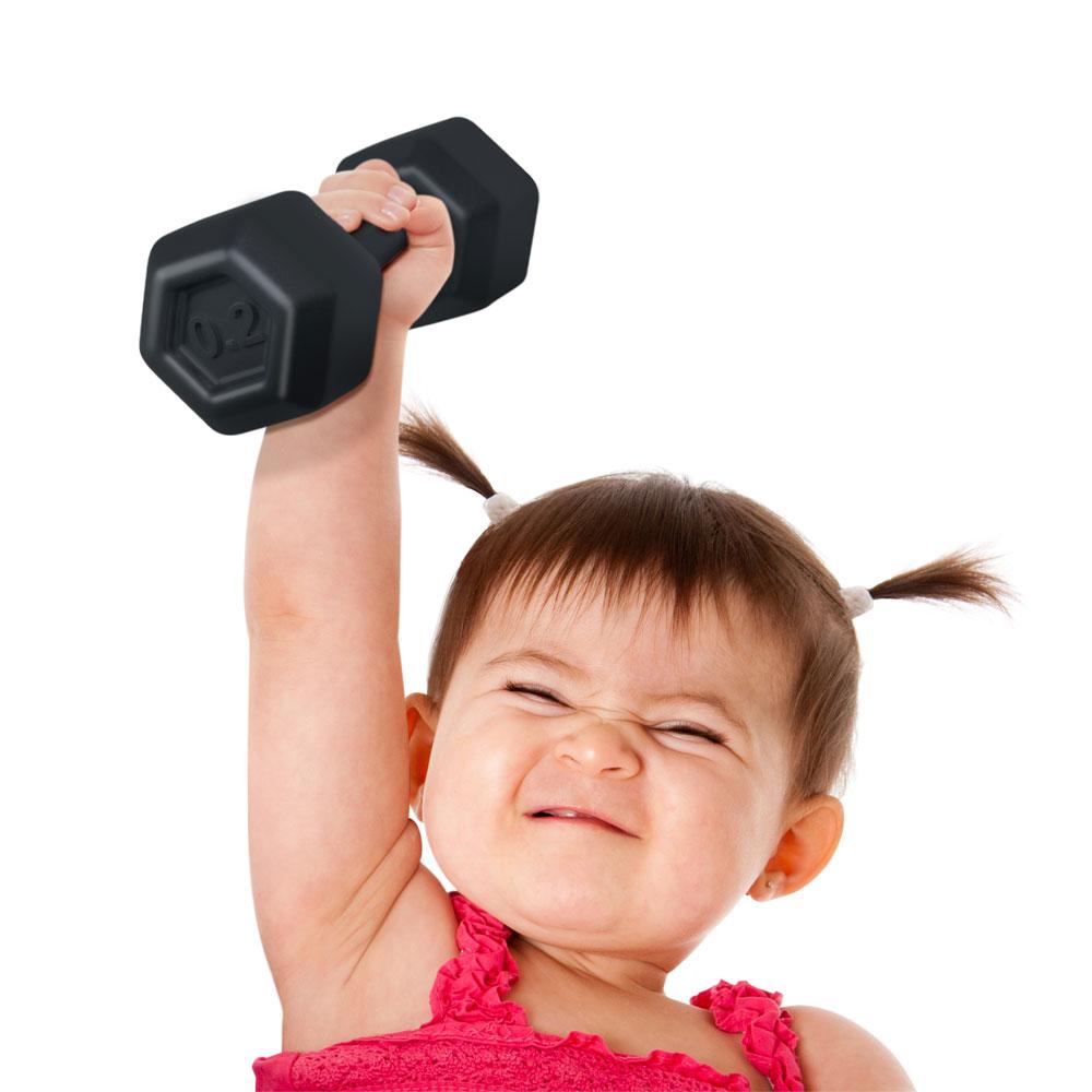 Toddler lifting a black dumbbell rattle with determination, safe and BPA-free toy for baby exercise fun.