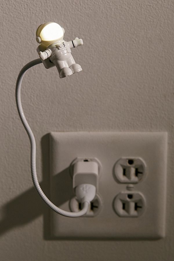 USB Astronaut Light plugged into outlet with illuminated spaceman head on flexible adjustable neck.