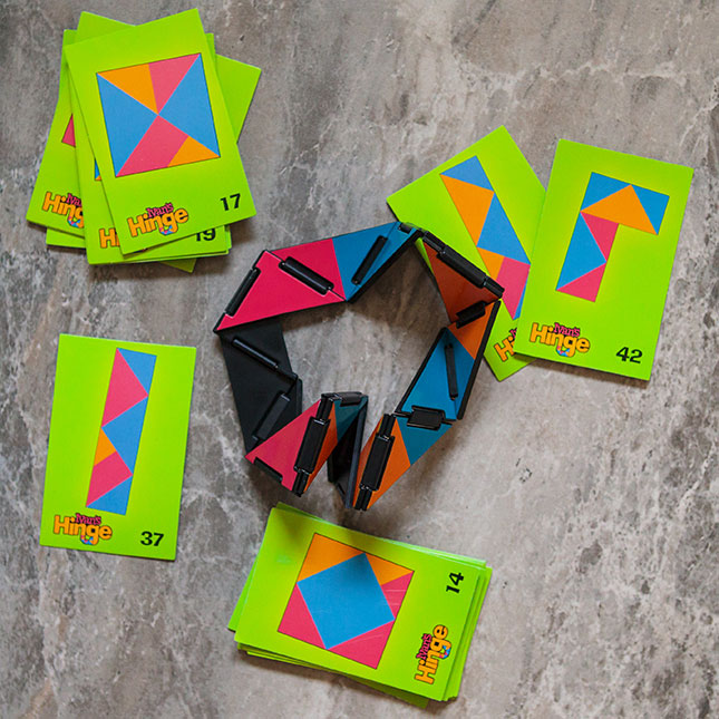 Ivan's Hinge articulating toy with colorful hinged pieces and pattern cards for creative, fidgety fun and challenge.