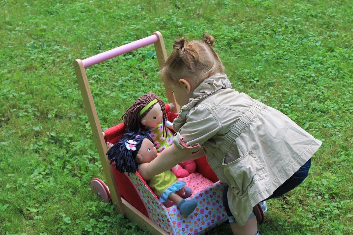 Soft Doll | Cari being played with by a toddler, showing its soft body and colorful outfit in a toy stroller.