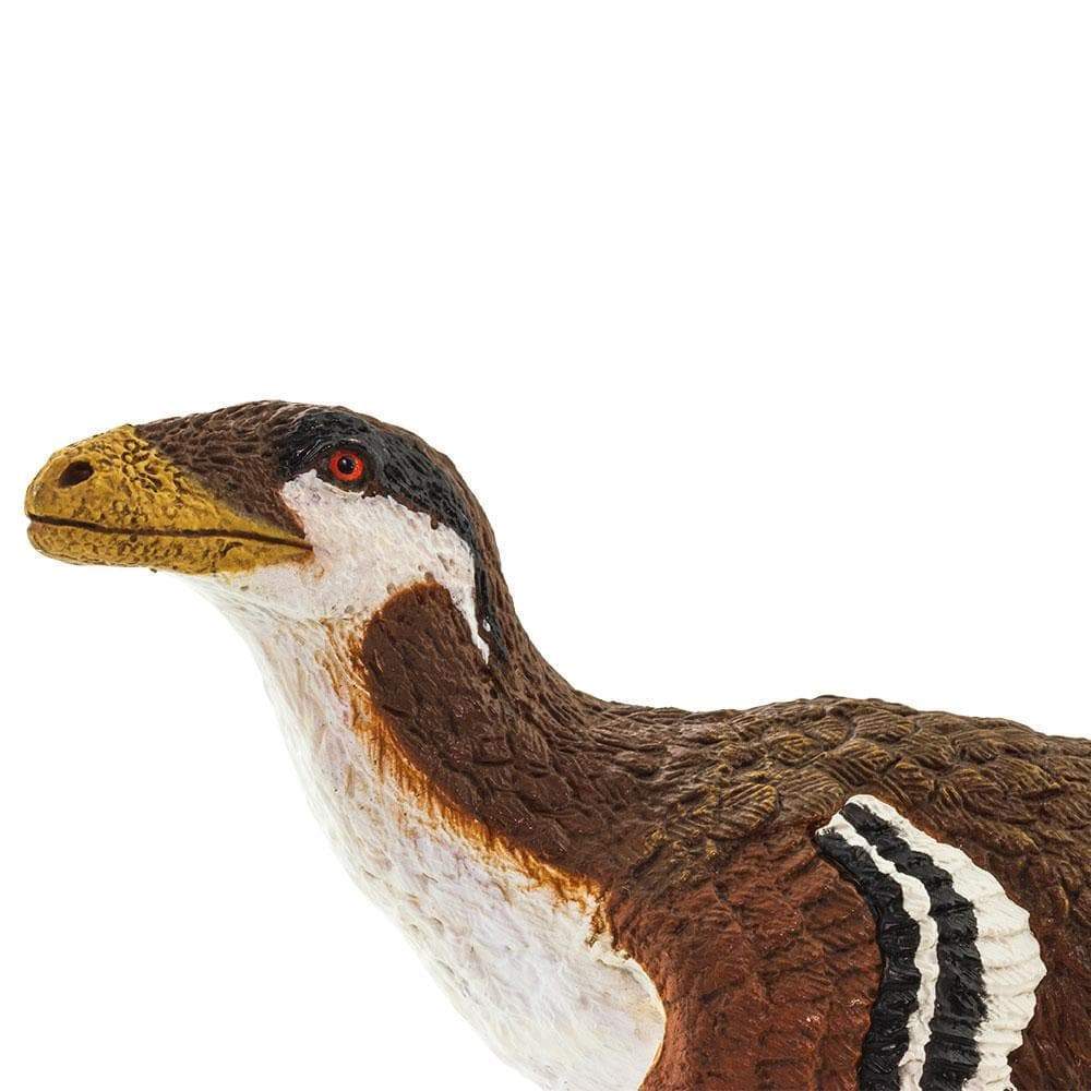 Deinonychus toy figure with feather details, folded wings, and realistic coloring in a resting pose.
