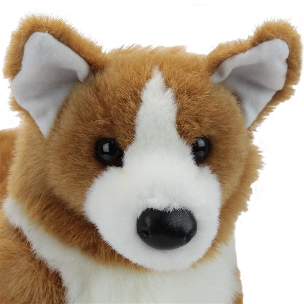 Close-up of Corgi Ingrid plush with tan and white fluffy fur and classic upright ears.