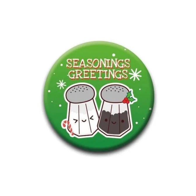 Seasonings Greetings Button with cute salt and pepper shakers on a green background, perfect for holiday fun.