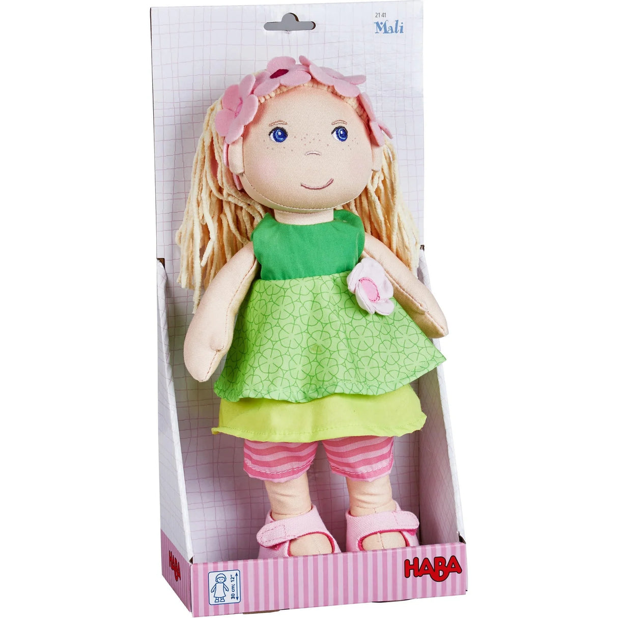 Soft Doll | Mali with embroidered face, green dress, flower headband, blonde chenille hair, and removable shoes in packaging.