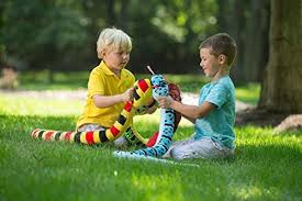 Green Rock Rattler Snake stuffed toy with fuzzy green fur and black spots, perfect for kids cuddling and playtime.