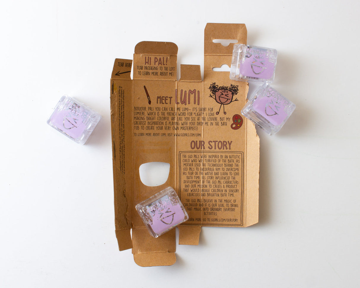 Glo Pals Purple light-up cubes with friendly faces displayed on open brown packaging with product story text.