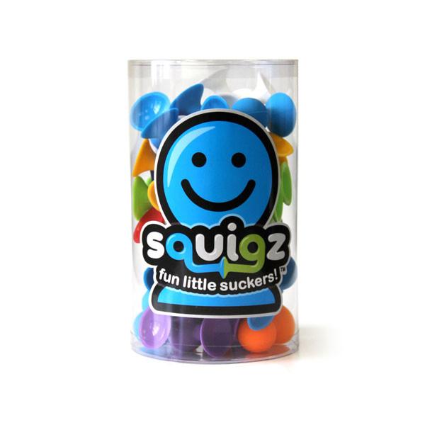 Clear container filled with colorful Squigz toy pieces, flexible silicone suckers for creative play and connection.