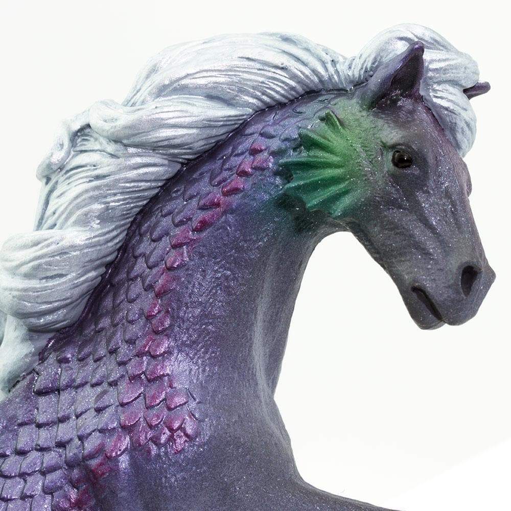 Close-up of Merhorse figure showing horse head, silvery mane, and pearlescent purple scales with green fins on blue-gray body.
