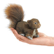 Red Squirrel Finger Puppet shown resting on a hand, featuring soft fur and lifelike design for children ages 3 and up.