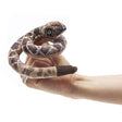 Rattlesnake Finger Puppet coiled on finger with printed snakeskin and rattle, designed for ages 3 and up.