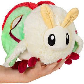 Luna Moth Mini plush held in hand, featuring soft green and cream colors with red accents and big friendly eyes.