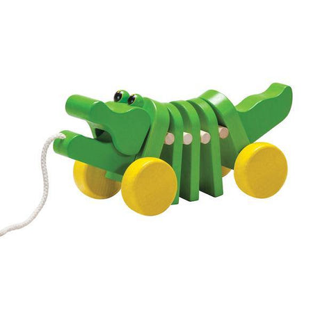 Alligator Pulltoy wooden toddler toy with green body, yellow wheels, moves head and tail, makes click clack sound.