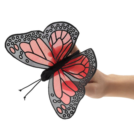 Monarch Butterfly Finger Puppet with sheer orange and black wings fluttering on a hand wearing the stretchy nylon puppet.