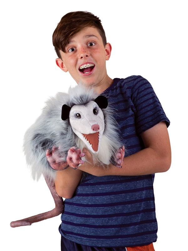 Boy holding the realistic and creepy yet cute Opossum Puppet with animated mouth and rat-like tail.