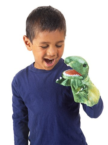 Boy playing with the green T-Rex Little Hand Puppet with moveable mouth and arms for dinosaur fun.