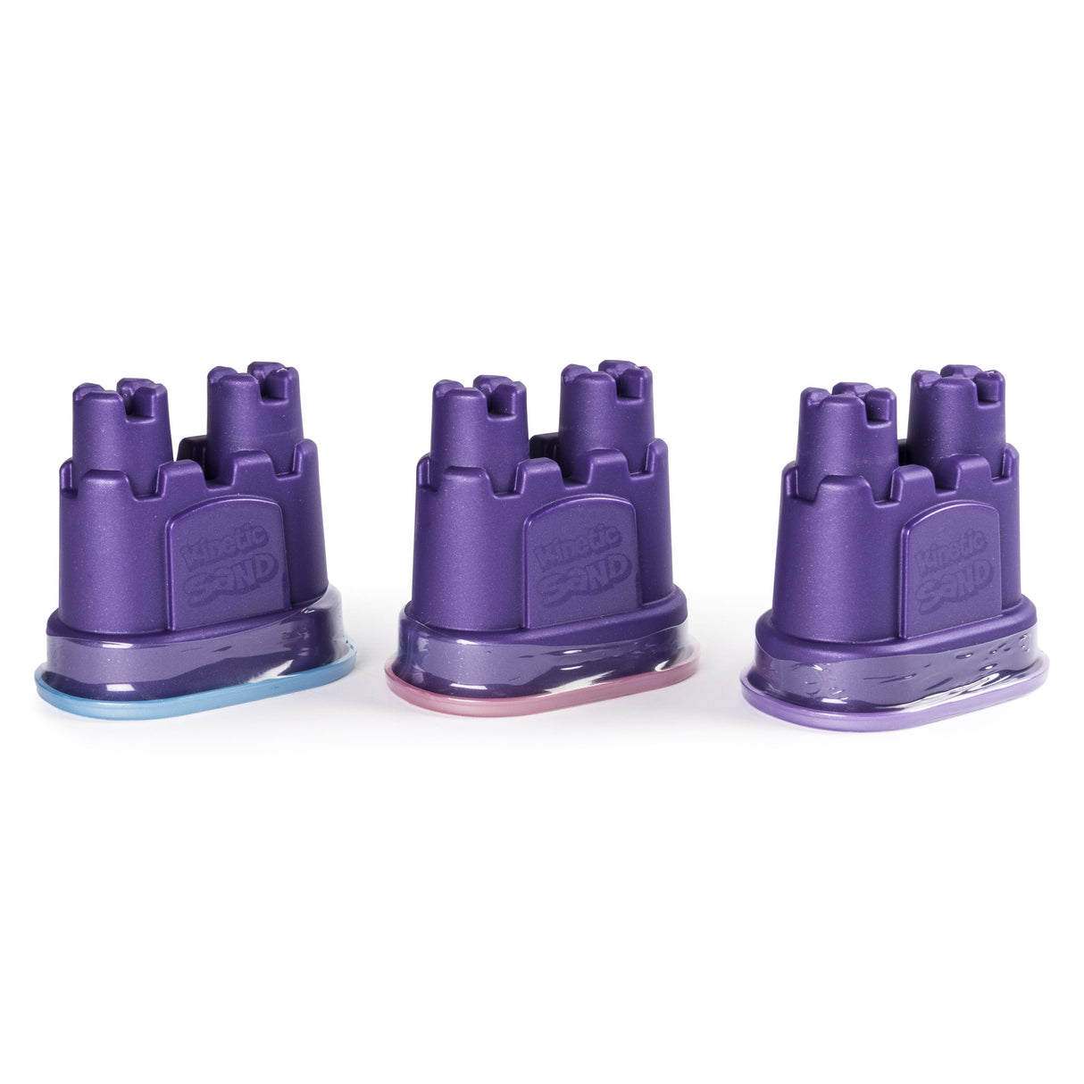 Three purple castle-shaped containers filled with pastel shimmering sand in the Kinetic Sand Shimmer Pack.