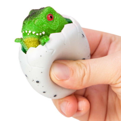 Squeezy Peek Hatcher Dino fragile egg cracked open with green dinosaur popping out held in hand toy for kids.
