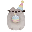 Pusheen Birthday Cake plush with smiling cat in pastel party hat holding a shimmering birthday cake with candle.