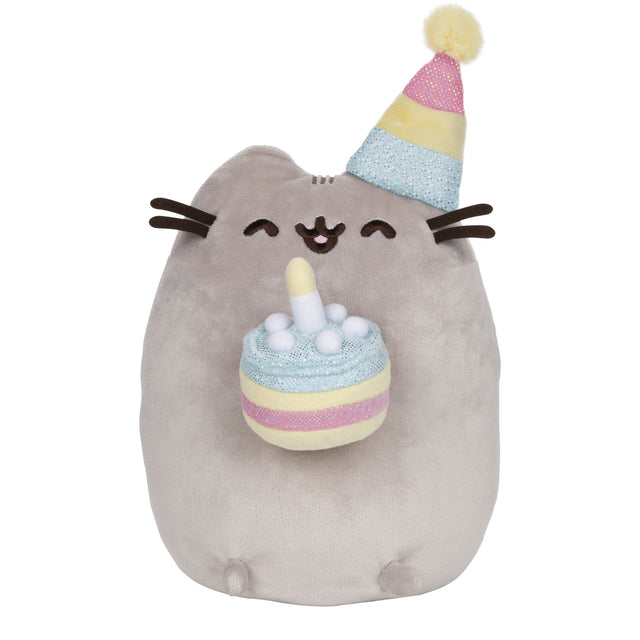Pusheen Birthday Cake plush with smiling cat in pastel party hat holding a shimmering birthday cake with candle.