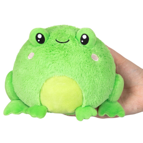 Frog Snackers plush toy with soft green fur, cute smile, and bean-filled body held in a hand, perfect for all ages.