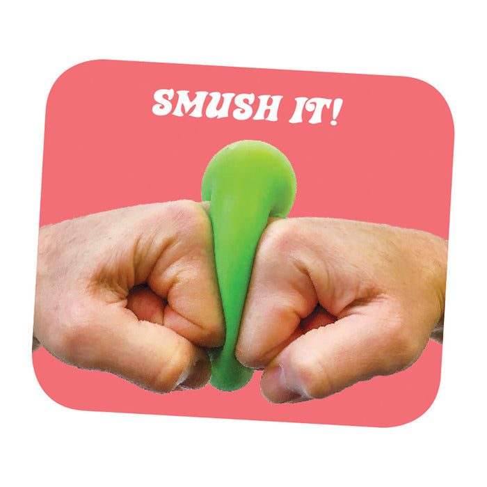 Hands squeezing a green NeeDoh Groovy Glob stress ball against a pink background with "SMUSH IT!" text.