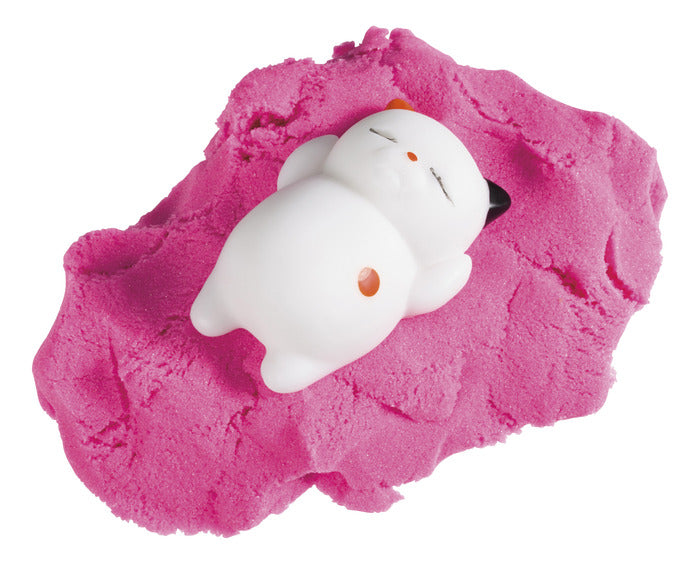 Laid back kitty figure resting on bright pink moldable sand in the Kitty Litter Box product set.