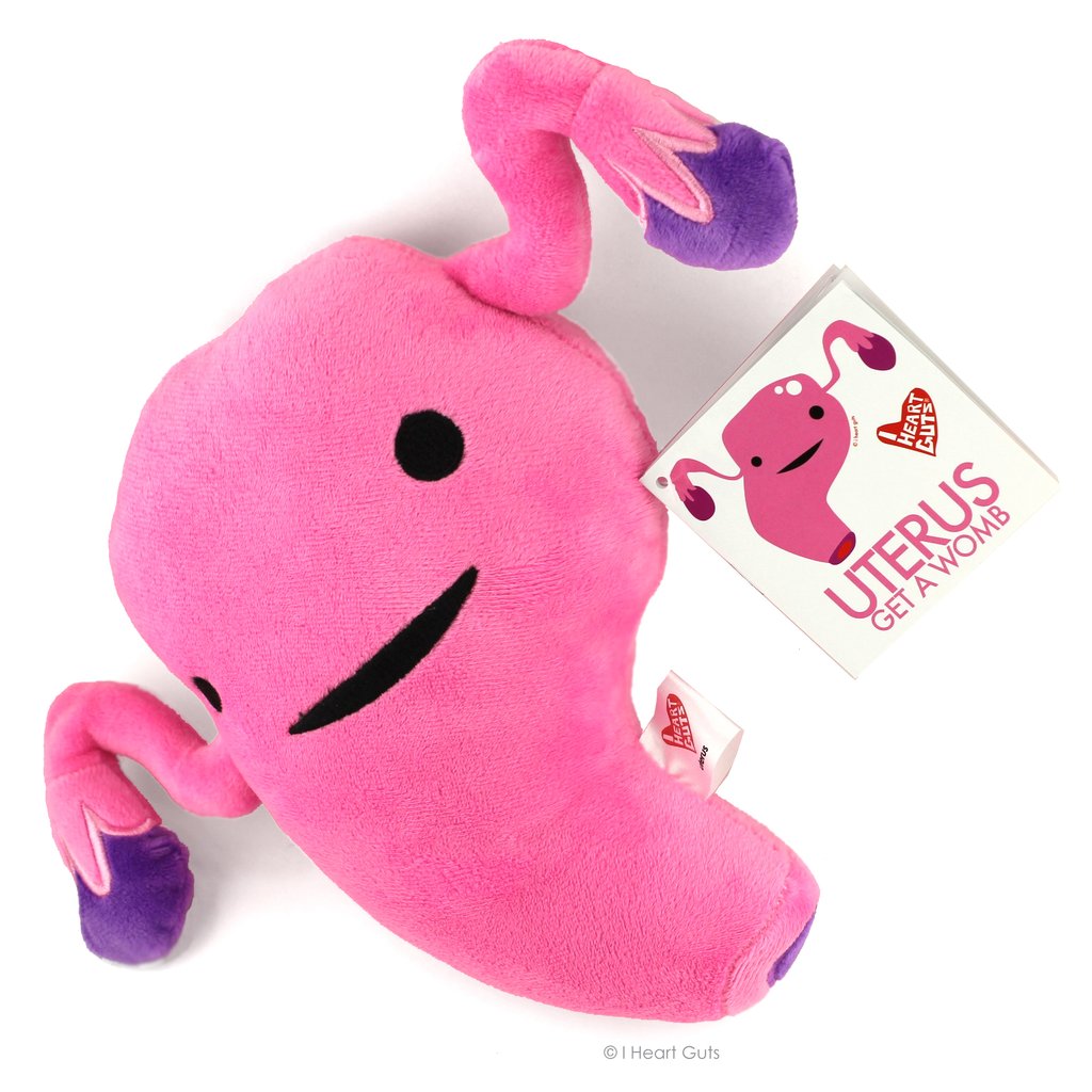 Pink fluffy plush toy shaped like a uterus with smiling face and educational hangtag for the product Uterus.