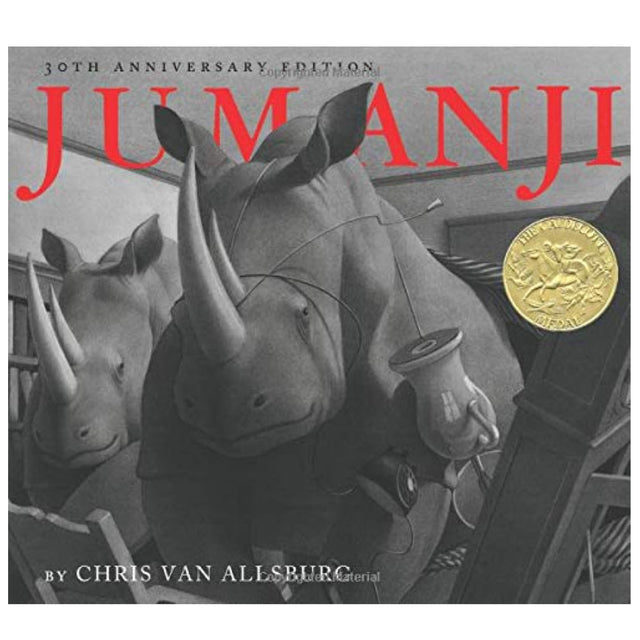 Jumanji book cover showing two rhinoceroses bursting through house walls in a fantasy adventure scene.