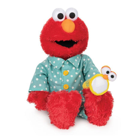 Bedtime Elmo plush in blue polka-dot pajamas holding flashlight with soft LED light, perfect for cozy bedtime hugs.