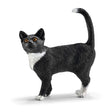 Cat Standing figurine showing a black and white cat with alert eyes and raised tail in a graceful posture.