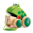 Pull Along Frog wooden toy with green frog design, open mouth, and wheels for toddlers aged 12+ months.