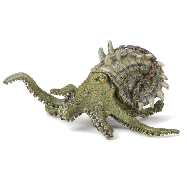 Kraken figure with dark sea green body, spiral shell with spines, rusted chain, and yellow eyes on white background.