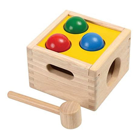 Punch & Drop wooden toy with colorful balls and mallet designed to improve fine motor skills and hand-eye coordination.