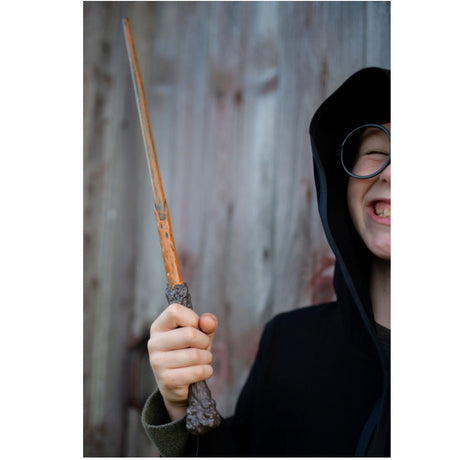 Child holding a Wizard Wand with a wavy wooden-inspired tip and dark brown handle, ready for magical adventures.