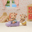 Reindeer Twins sitting and crawling figures with purple pushcart in a cozy dollhouse room setting for ages 3+