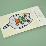 Gray Tabby Cat and Plant Sticker showing a cute gray tabby cat holding a potted plant vinyl sticker.