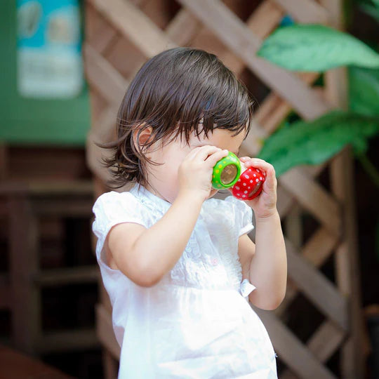 Child exploring outdoors with the Kaleidoscope Mushroom Green, a creative lens for imaginative play and discovery.