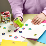 Depiction of child using the dinosaur sticker stamper on a sheet of paper. For ages 3 and up.
