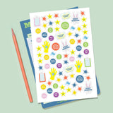 Colorful reward stickers with phrases and stars for motivating kids on their chore chart pad