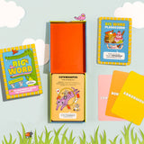 Colorful big word flashcards for kids with playful illustrations and fun definitions displayed on a light blue surface.