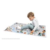 Child playing on the Crossroads White Valley Play Mat featuring snowy mountain roads and a railroad track.