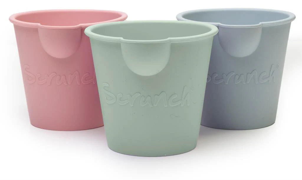 Three pastel-colored Scrunch Mini Bath Buckets in pink, green, and blue, perfect for bath or beach fun.
