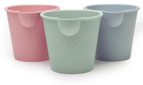 Three pastel-colored Scrunch Mini Bath Buckets in pink, green, and blue, perfect for bath or beach fun.